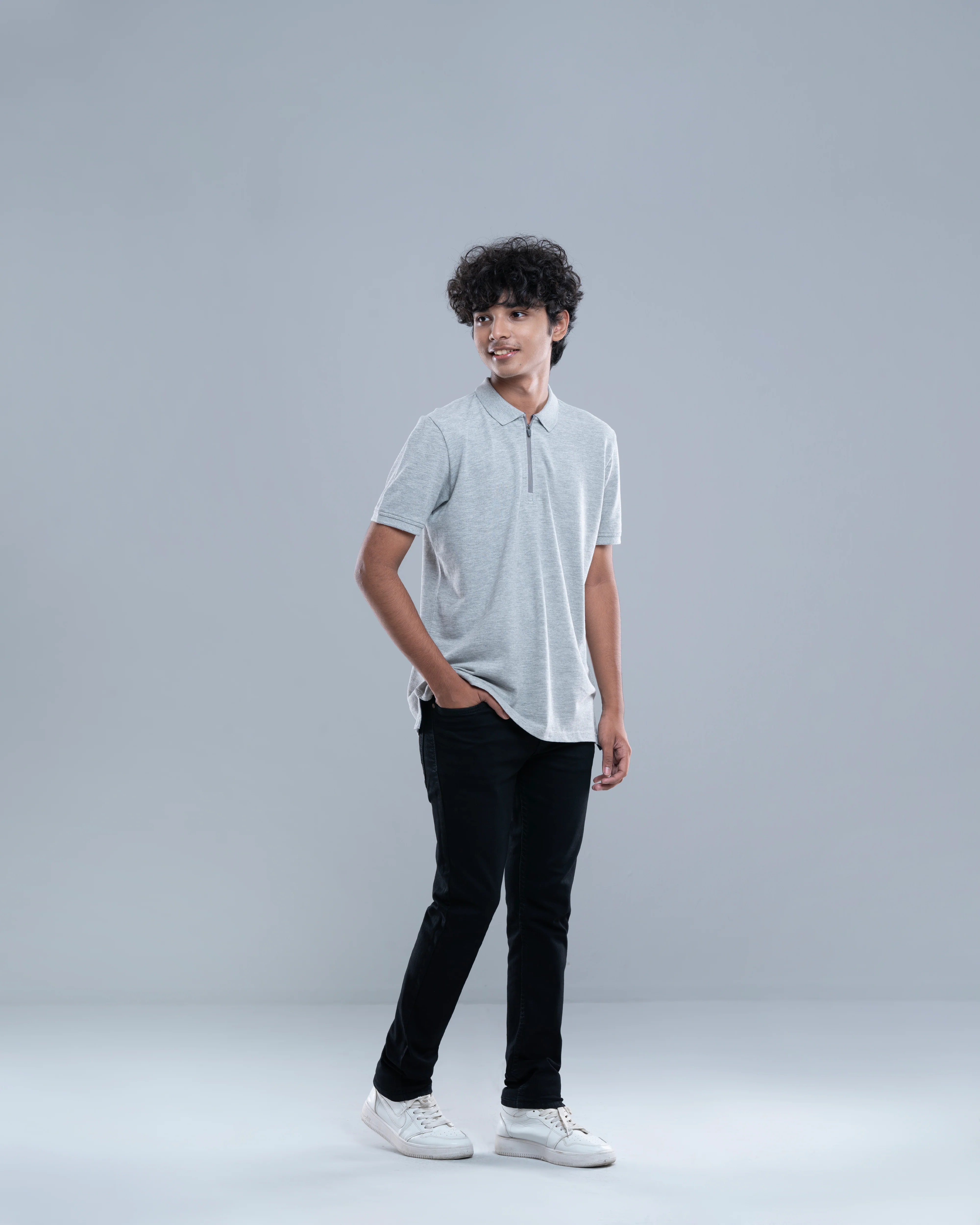 Boy wearing a grey polo top